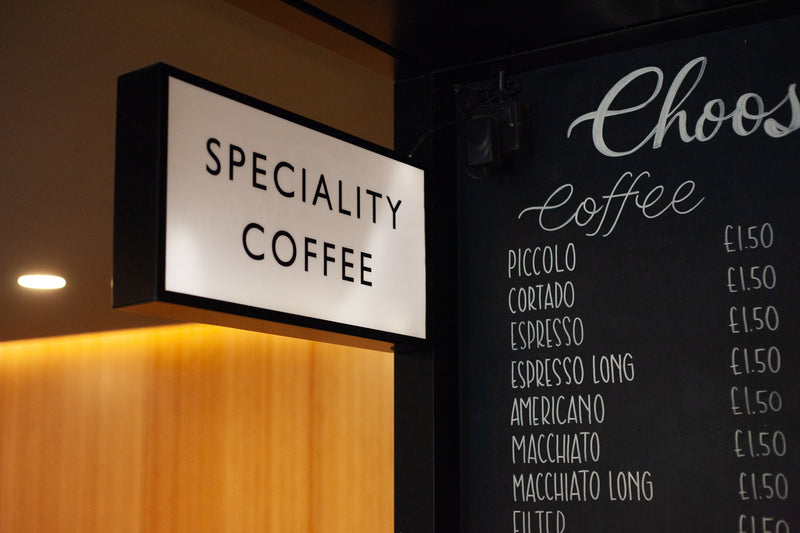 Specialty coffee sign and menu board in a coffee shop.